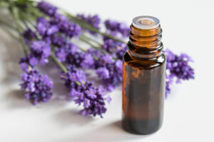 A bottle of lavender essential oil on a white background